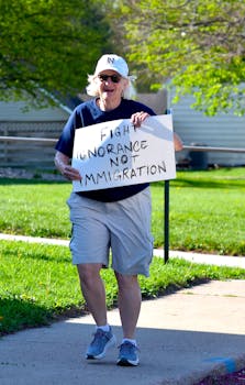Senior Woman Running with Hand Written Protest Sign in Small Town